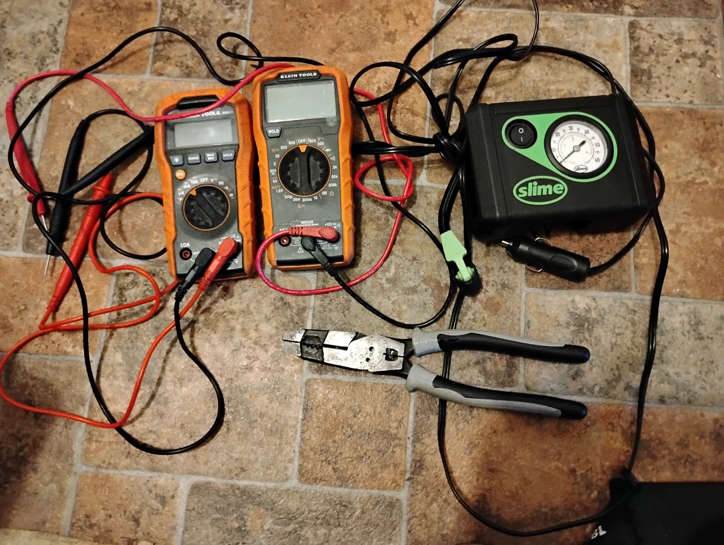 Two Klein Tools Multimeters and Slime Tire Inflator