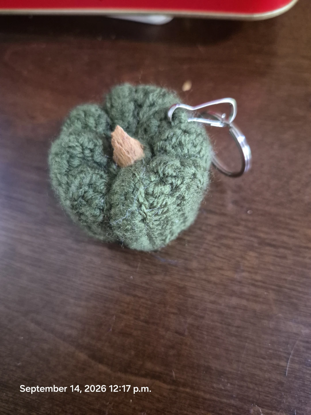 Hand-crocheted green pumpkin keychain