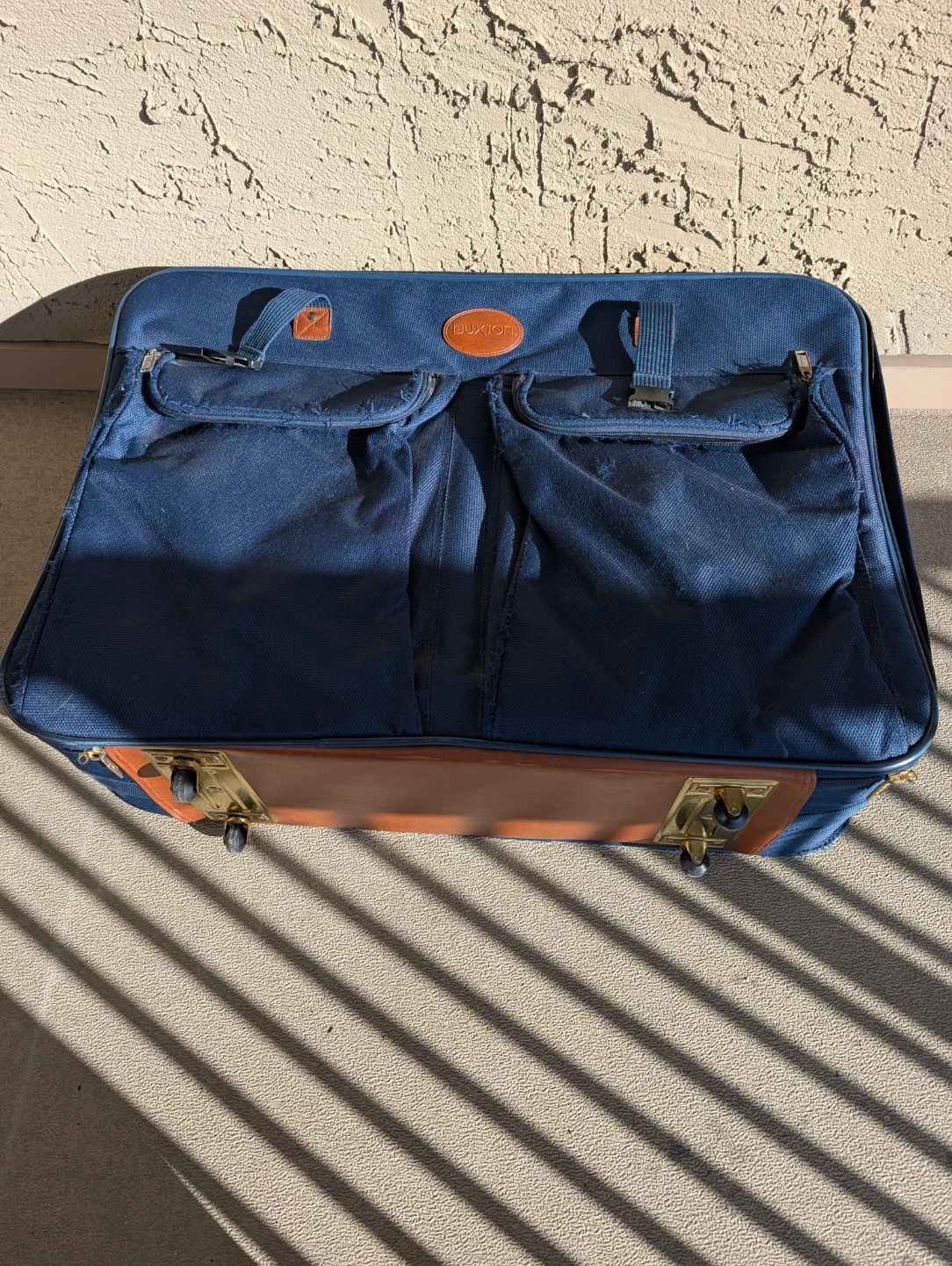 Buxton blue rolling suitcase