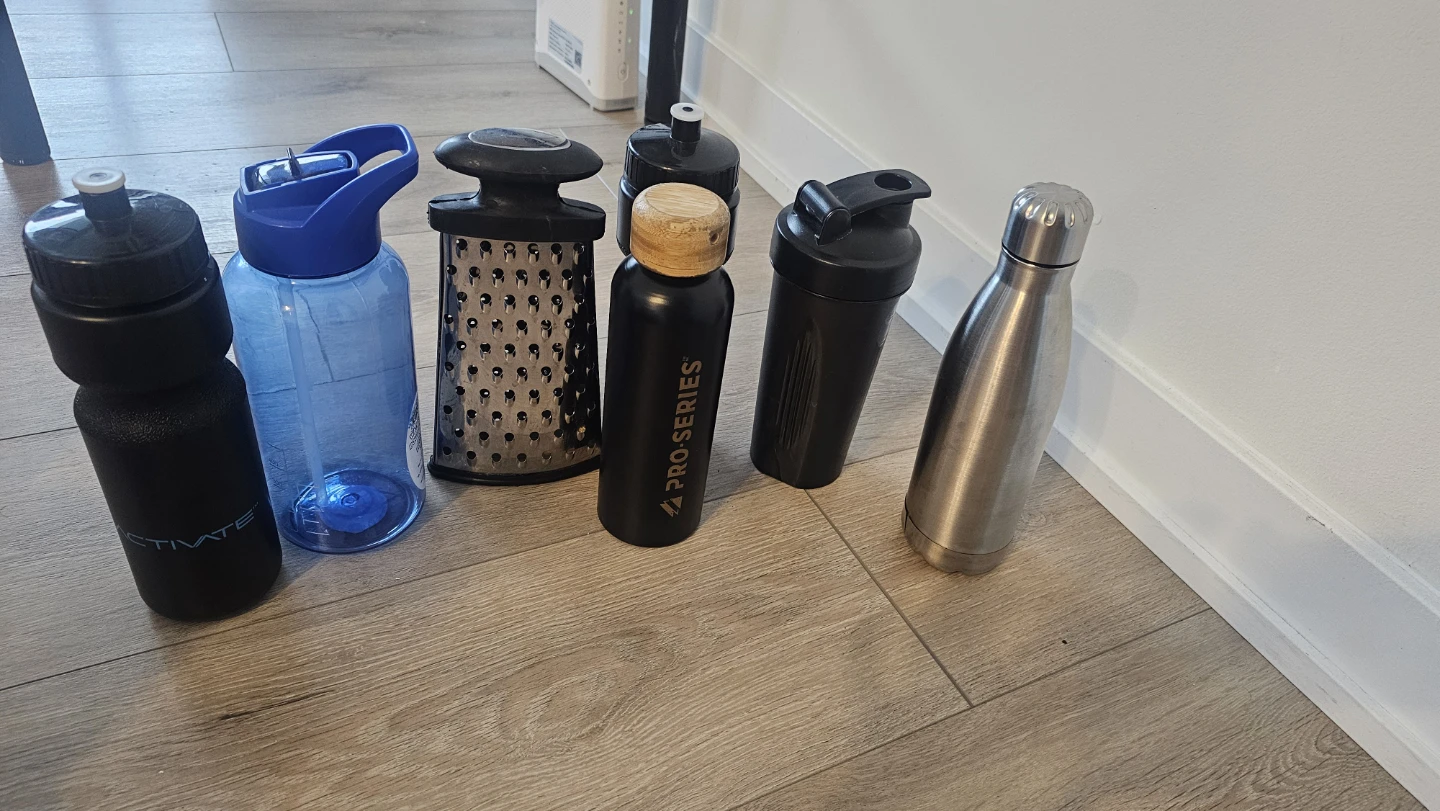 Assorted Water Bottles and Kitchen Grater