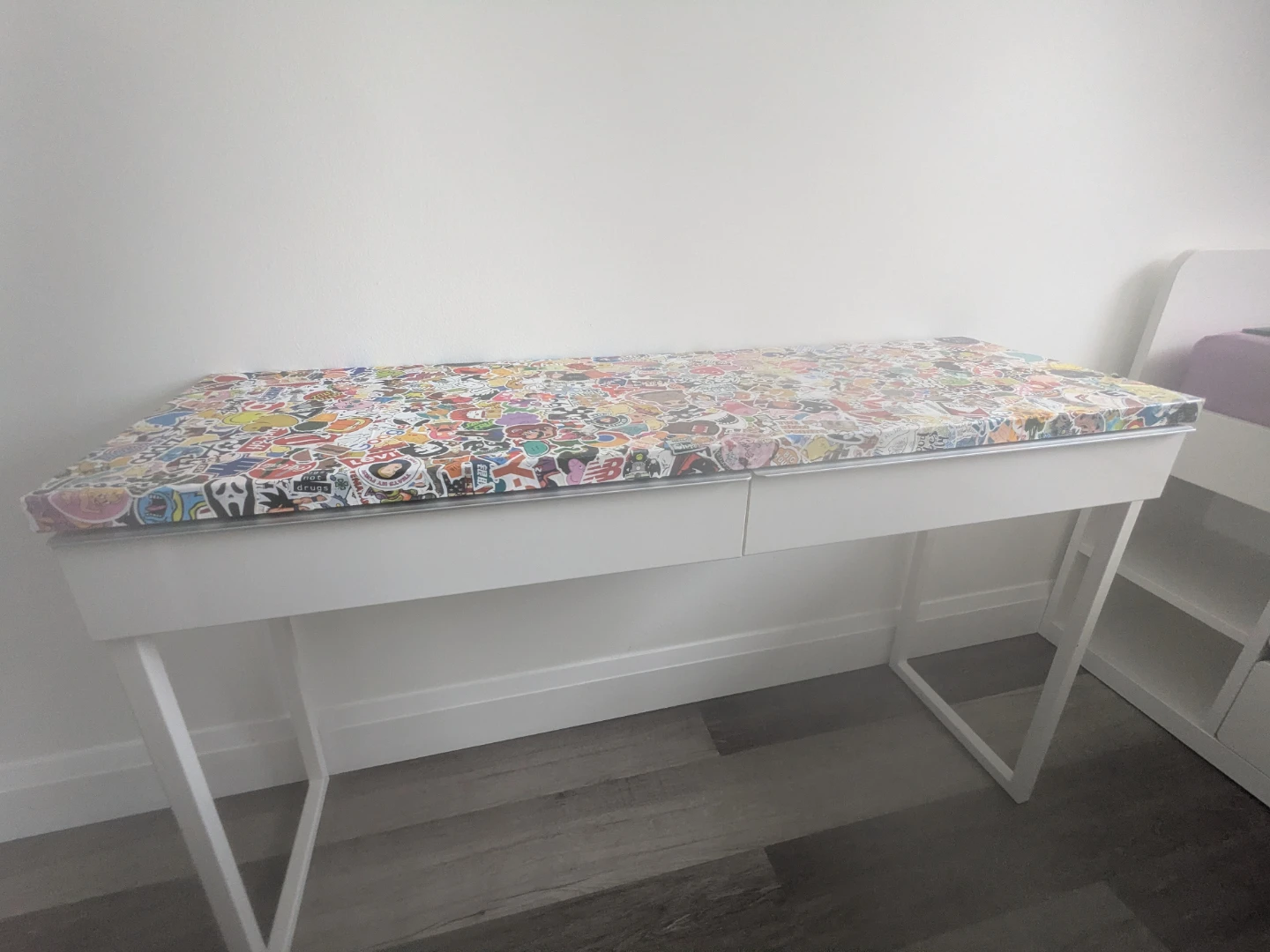 White desk with custom sticker-bombed top