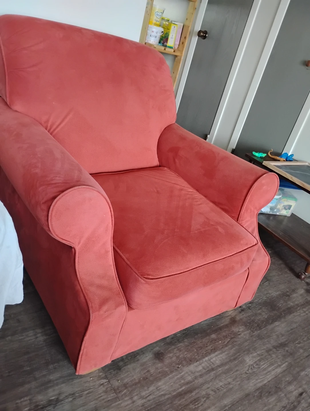 Red upholstered armchair . Salmon colour