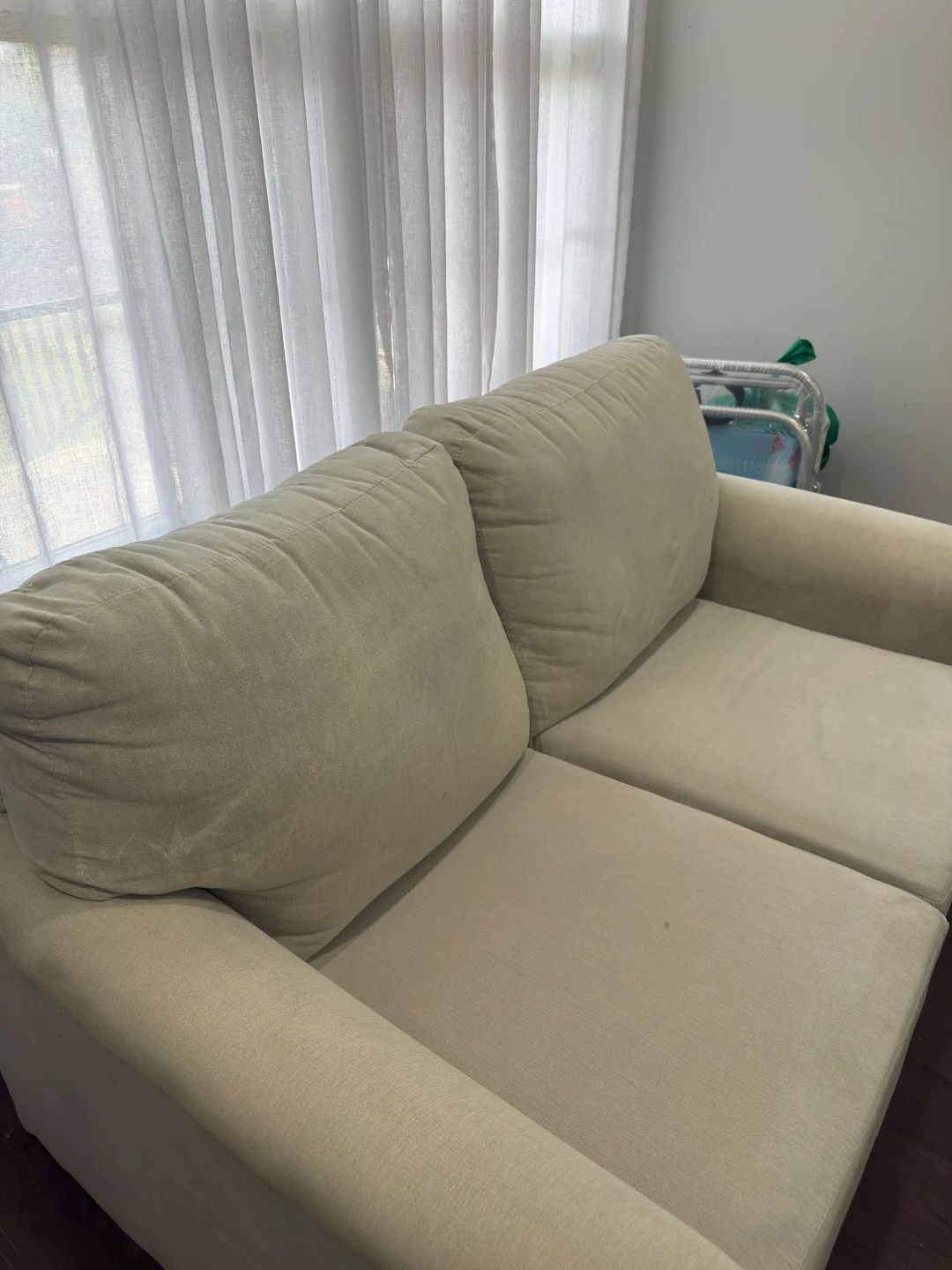 Cream-coloured two-seater sofa