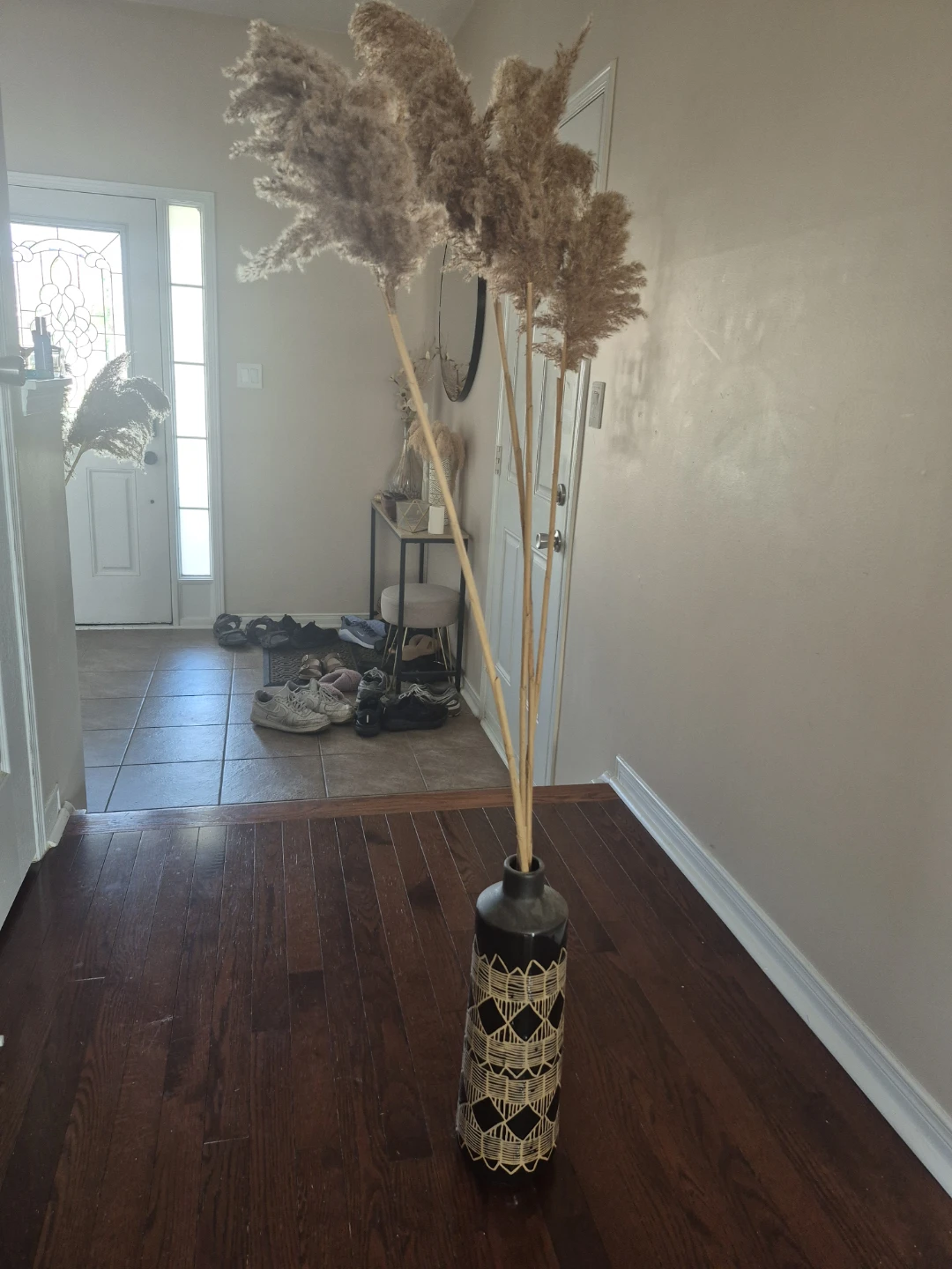 Black patterned vase with decorative grass