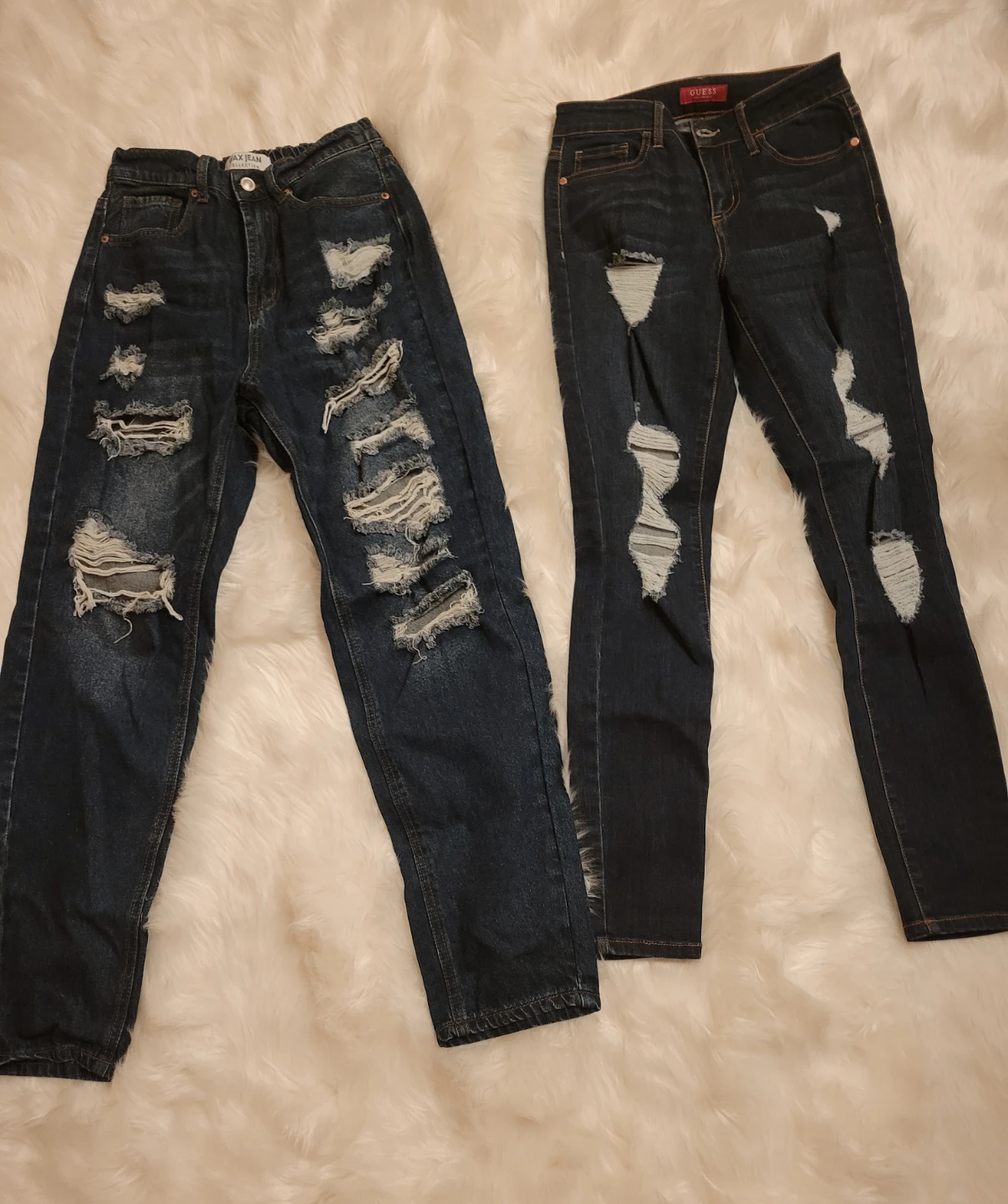 Two pairs of distressed blue jeans