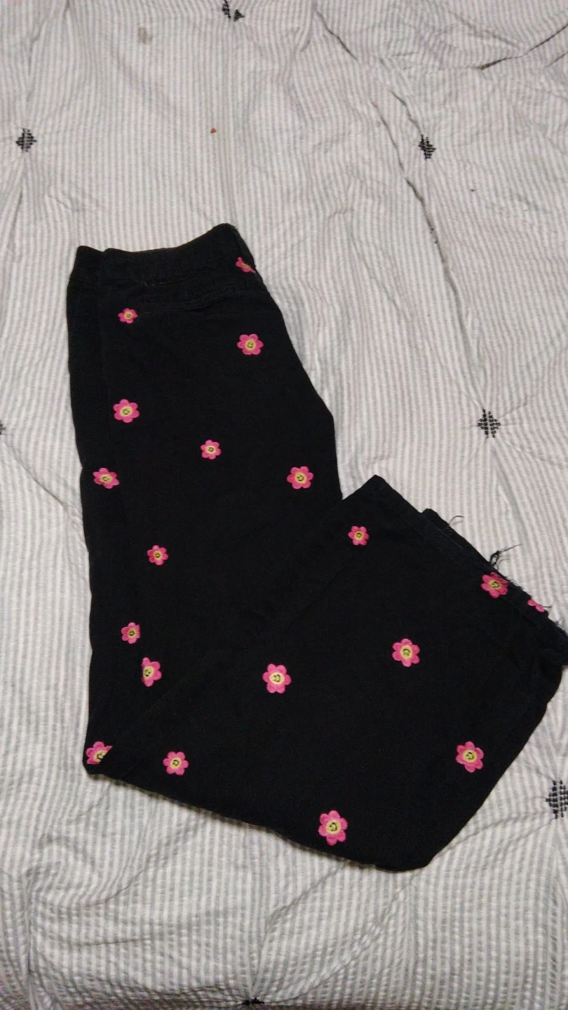 Black pants with pink flower embroidery