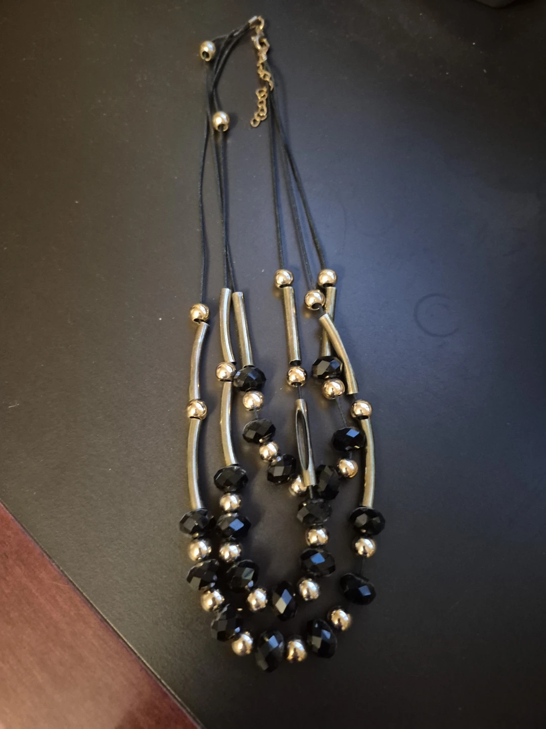 Black and gold tone layered bead necklace