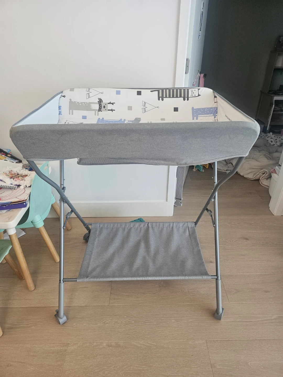 A baby changing table  with storage for baby clother and diaper