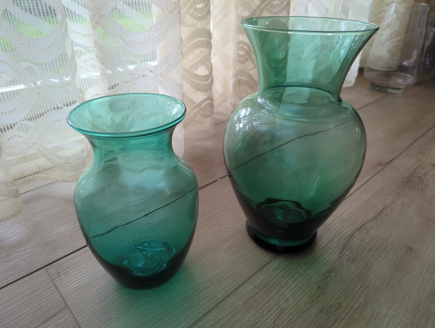 Set of two green glass vases