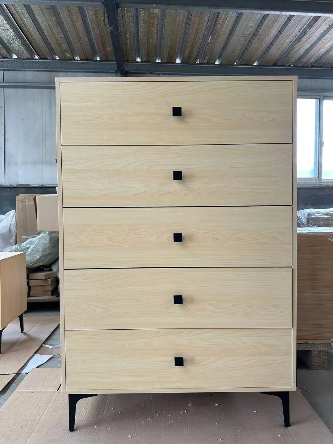 Five-drawer dresser with light wood finish