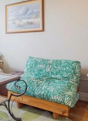 Like-new versatile wooden futon love seat/bed