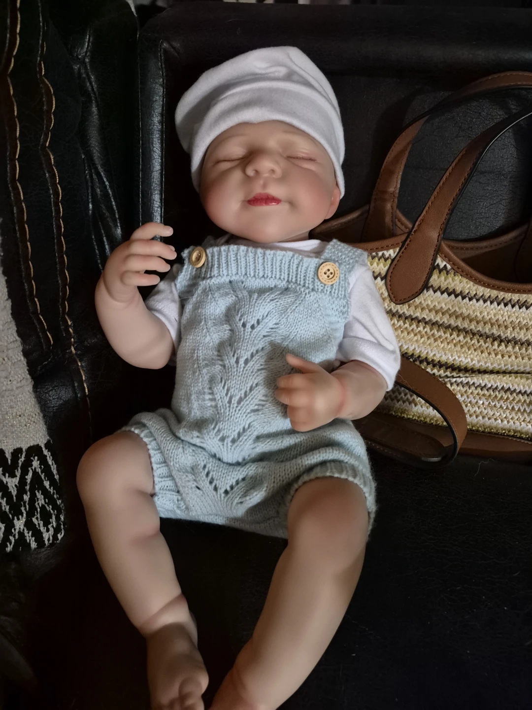 Reborn baby doll with blue knitted romper