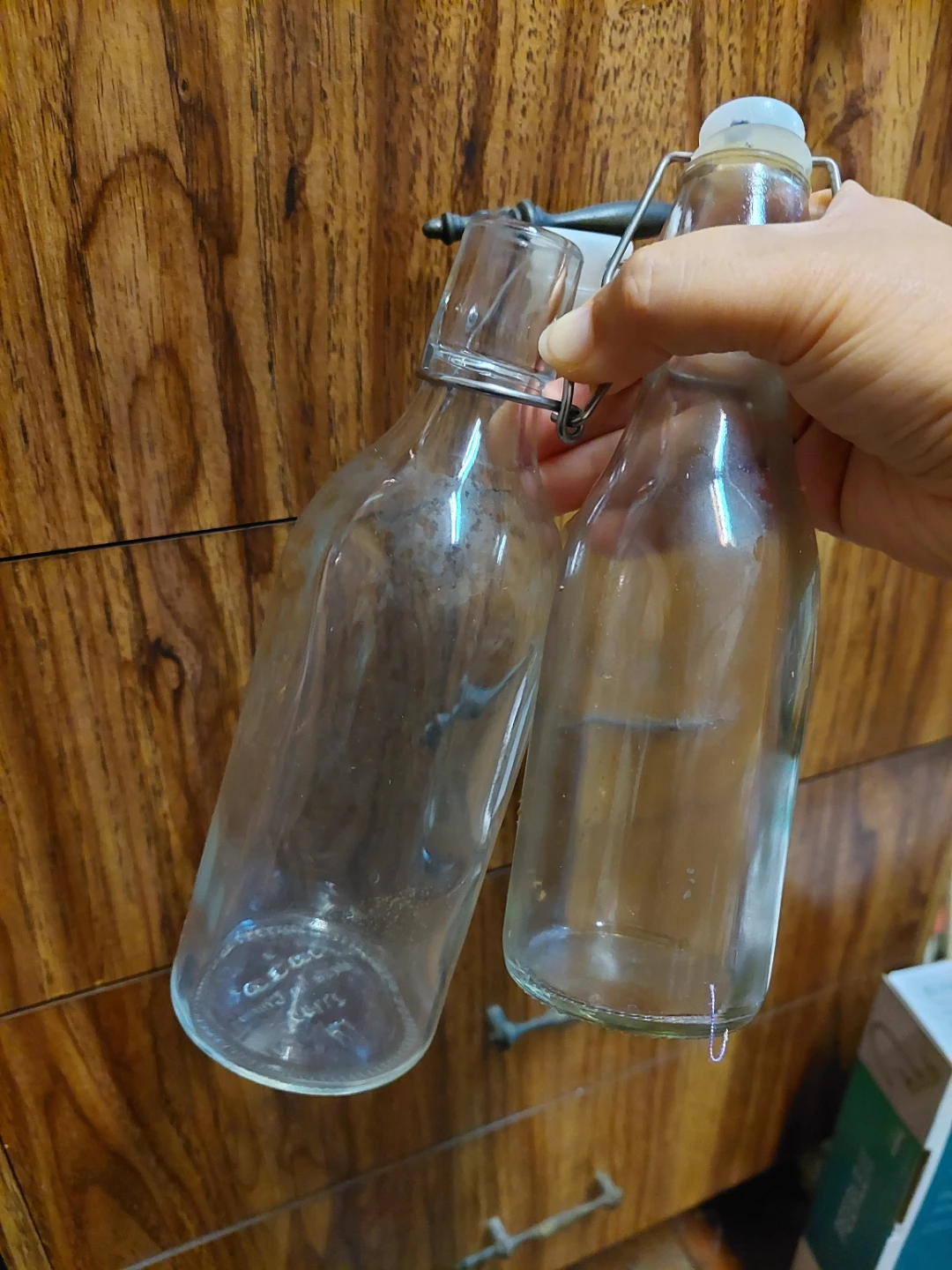 Two clear glass swing-top bottles 🏈