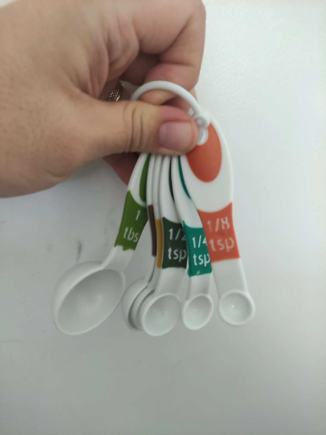 Set of multi-coloured plastic measuring spoons