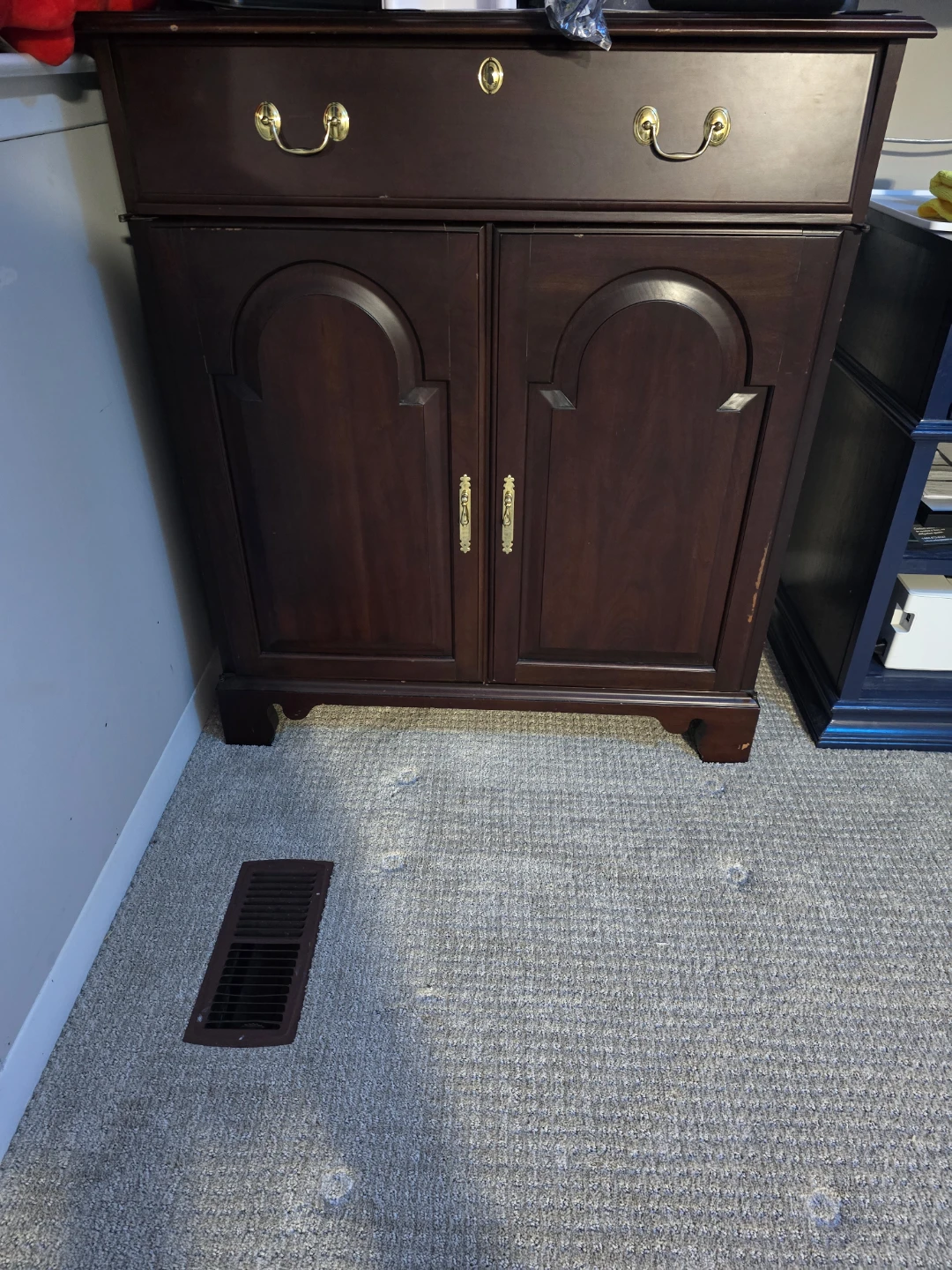 Dark wood storage cabinet with drawer