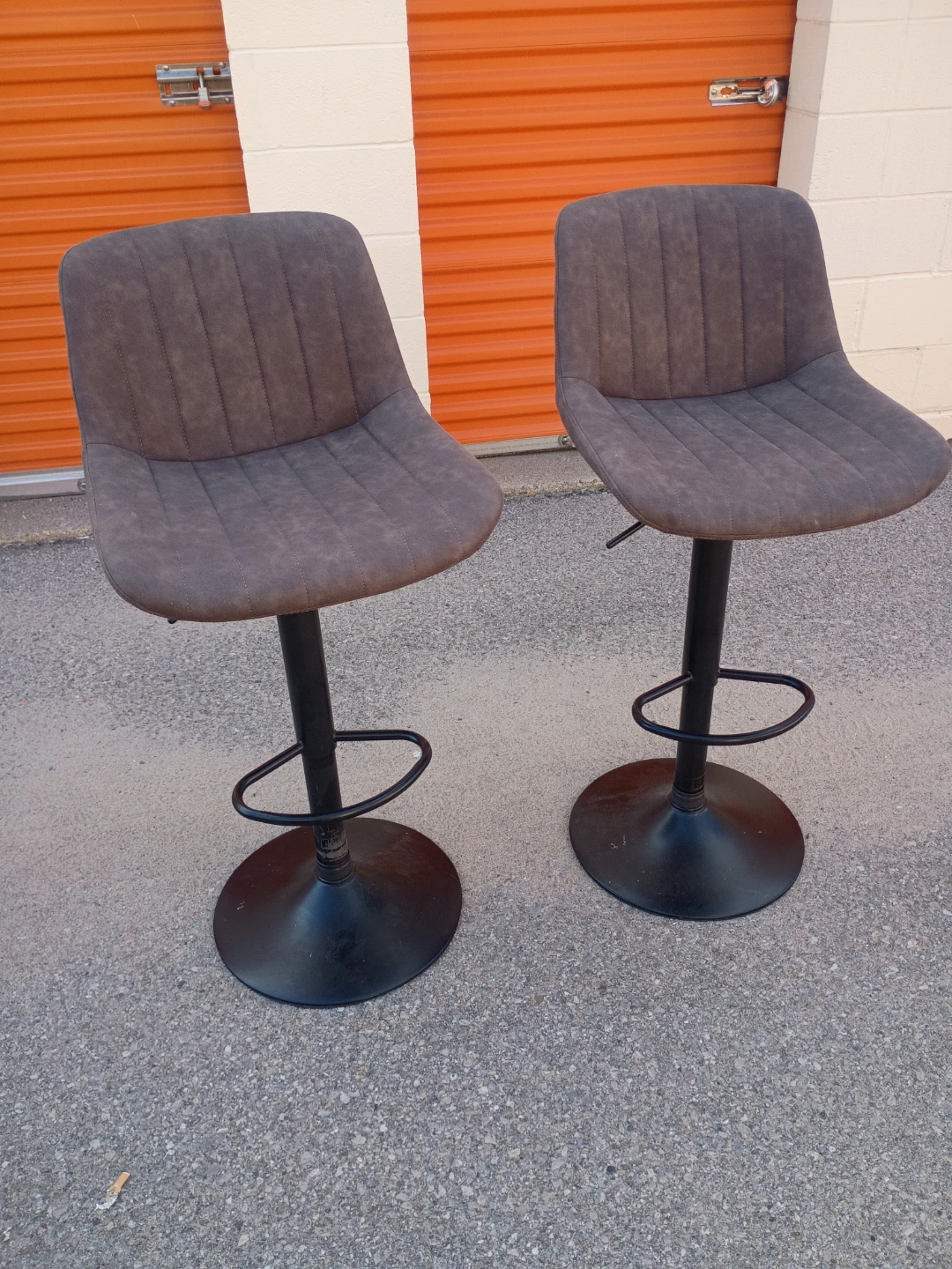 Two brown faux leather bar stools by Wayfair