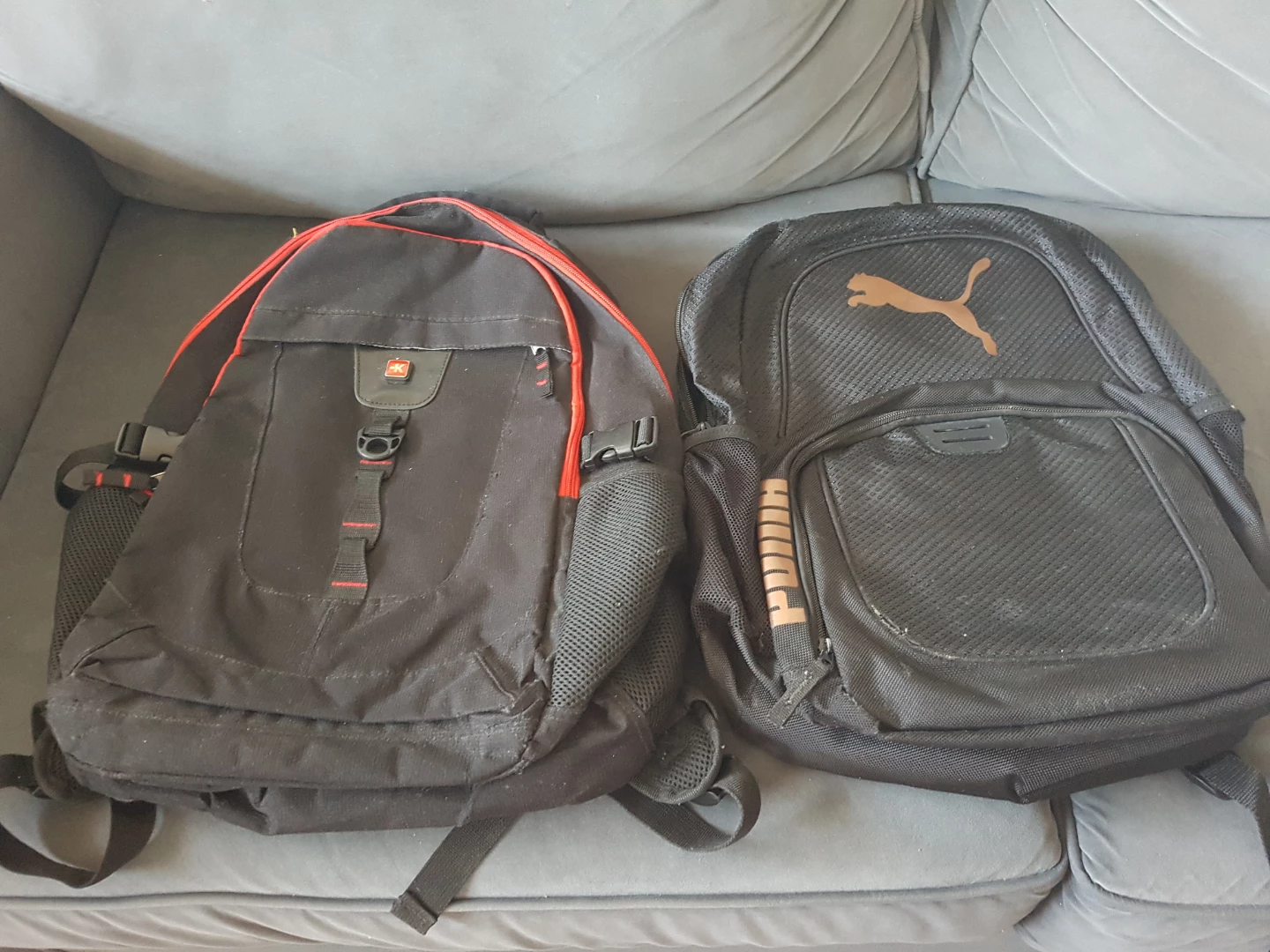 Two Black Backpacks: Puma and Swiss-style
