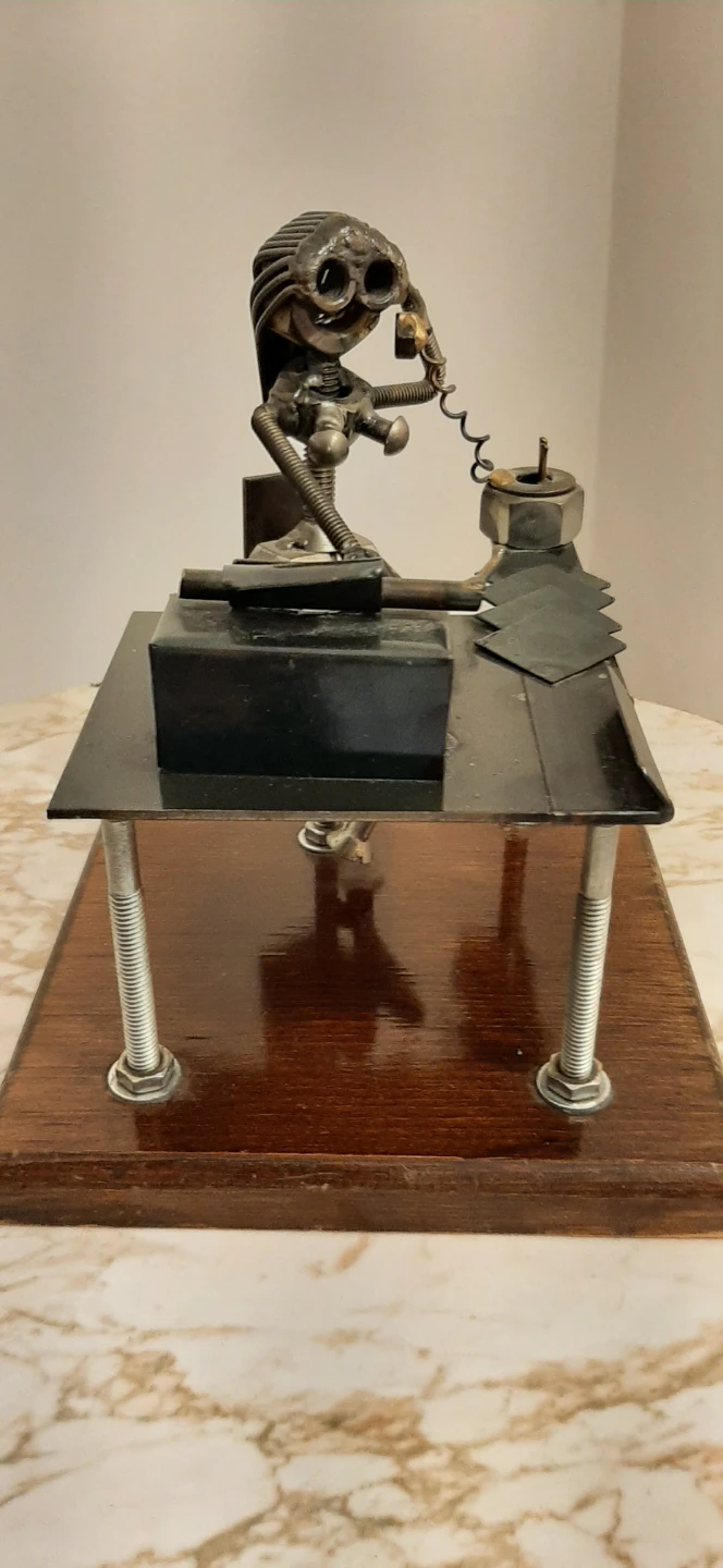 Metal art sculpture of an office worker at a desk - photo 5