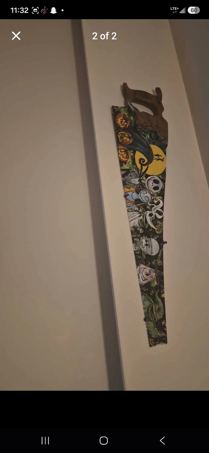 Two decorative hand-painted saws