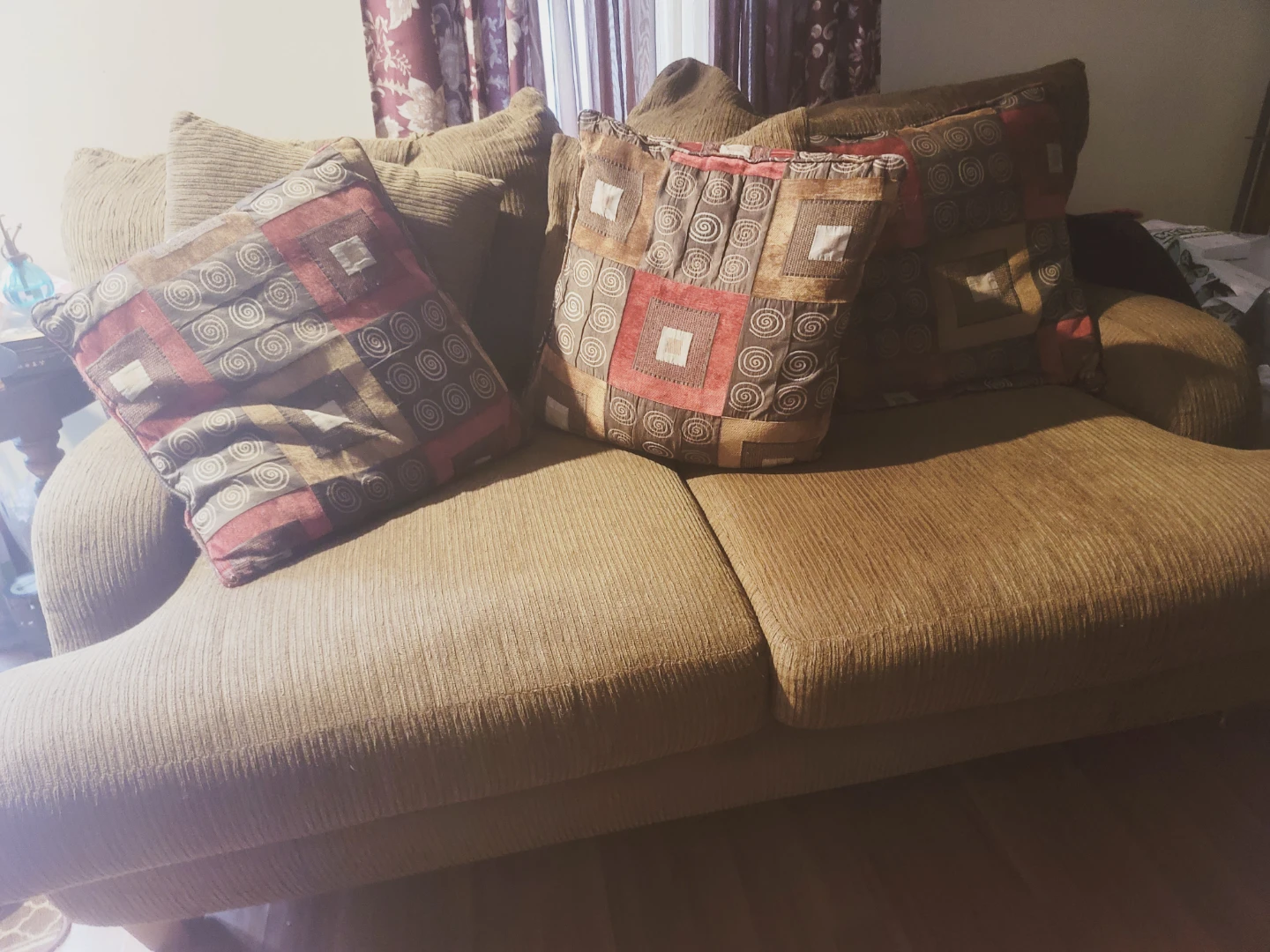 Brown Corduroy Sofa with Patterned Throw Pillows