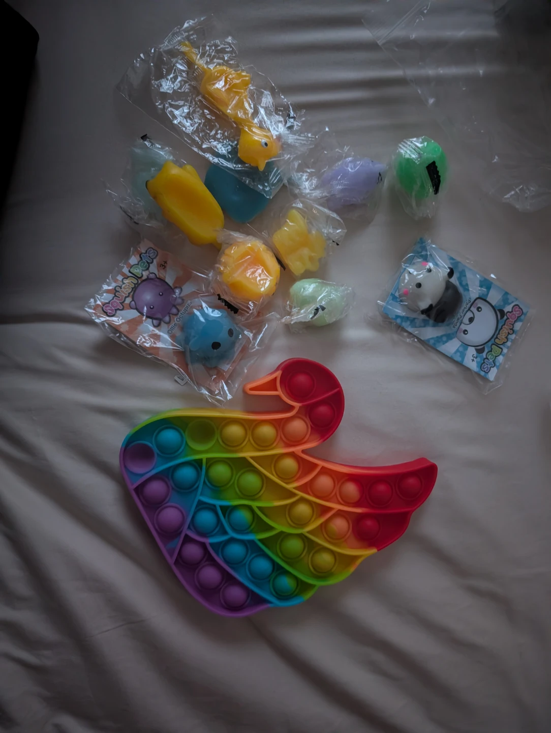 Lot of Squishy Toys and Rainbow Swan Pop-It Fidget Toy