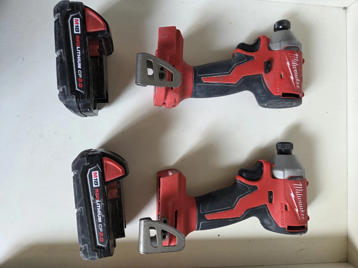Two Milwaukee M18 Brushless Impact Drivers with Batteries