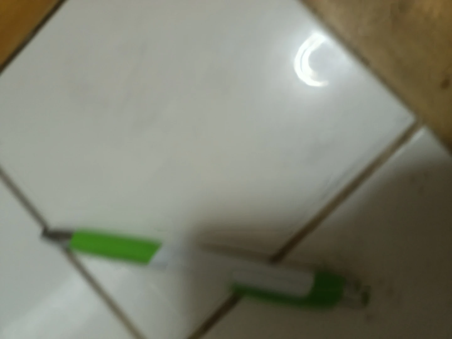 Green and white ballpoint pen🏈
