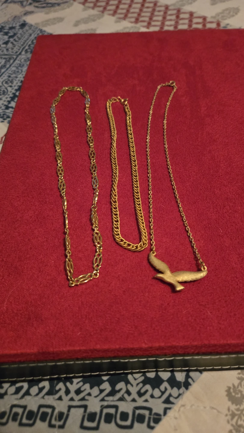 Set of three gold tone necklaces