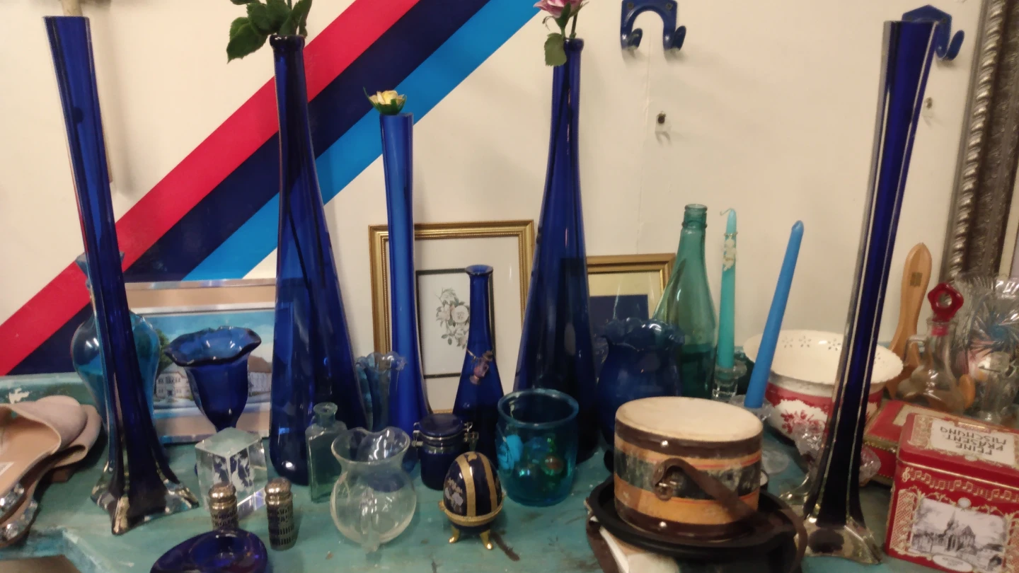 Set of four blue glass decorative vases