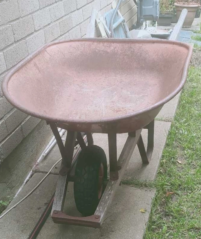 Red metal garden wheelbarrow