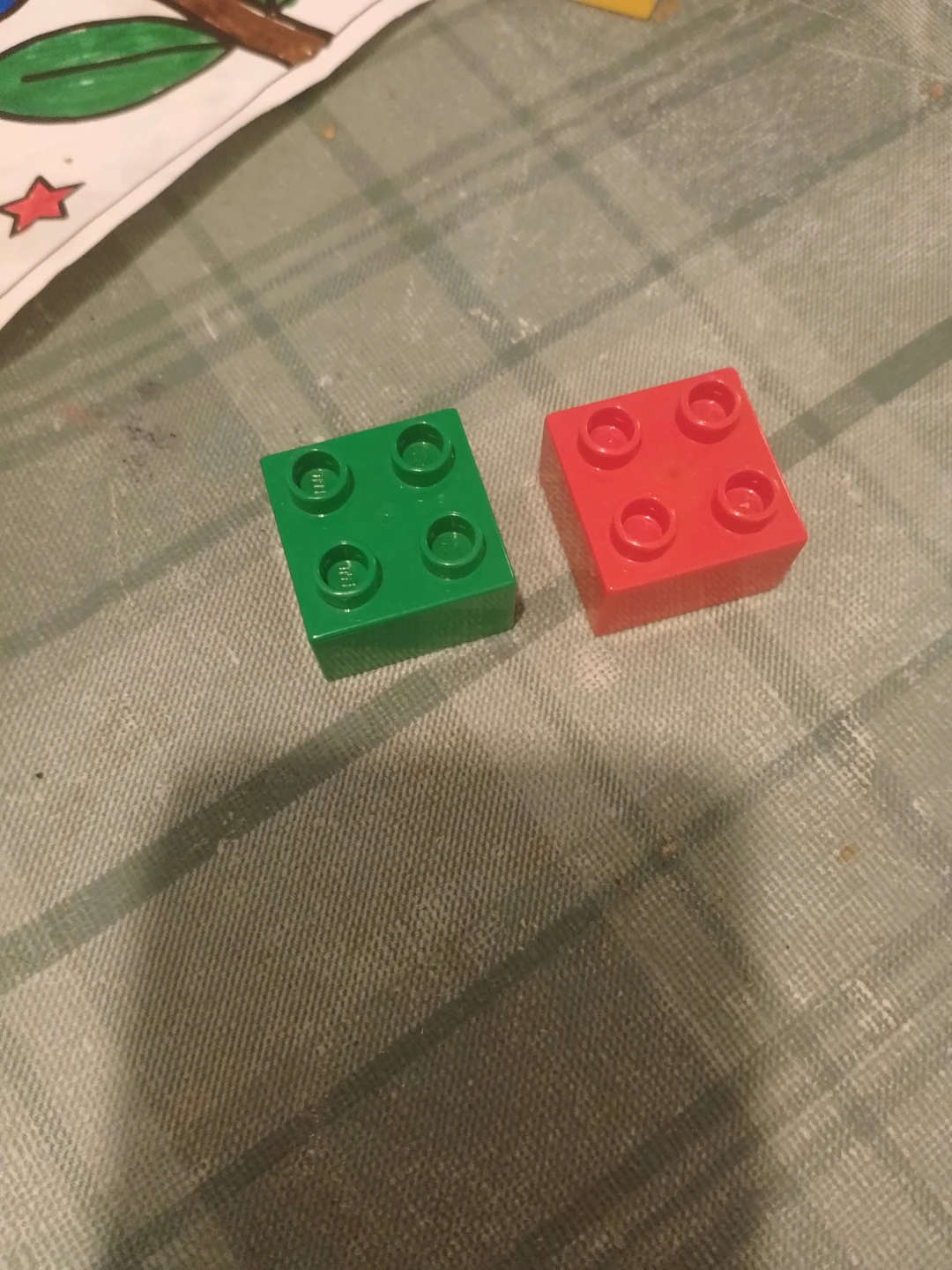 Two LEGO Duplo 2x2 building blocks🏈