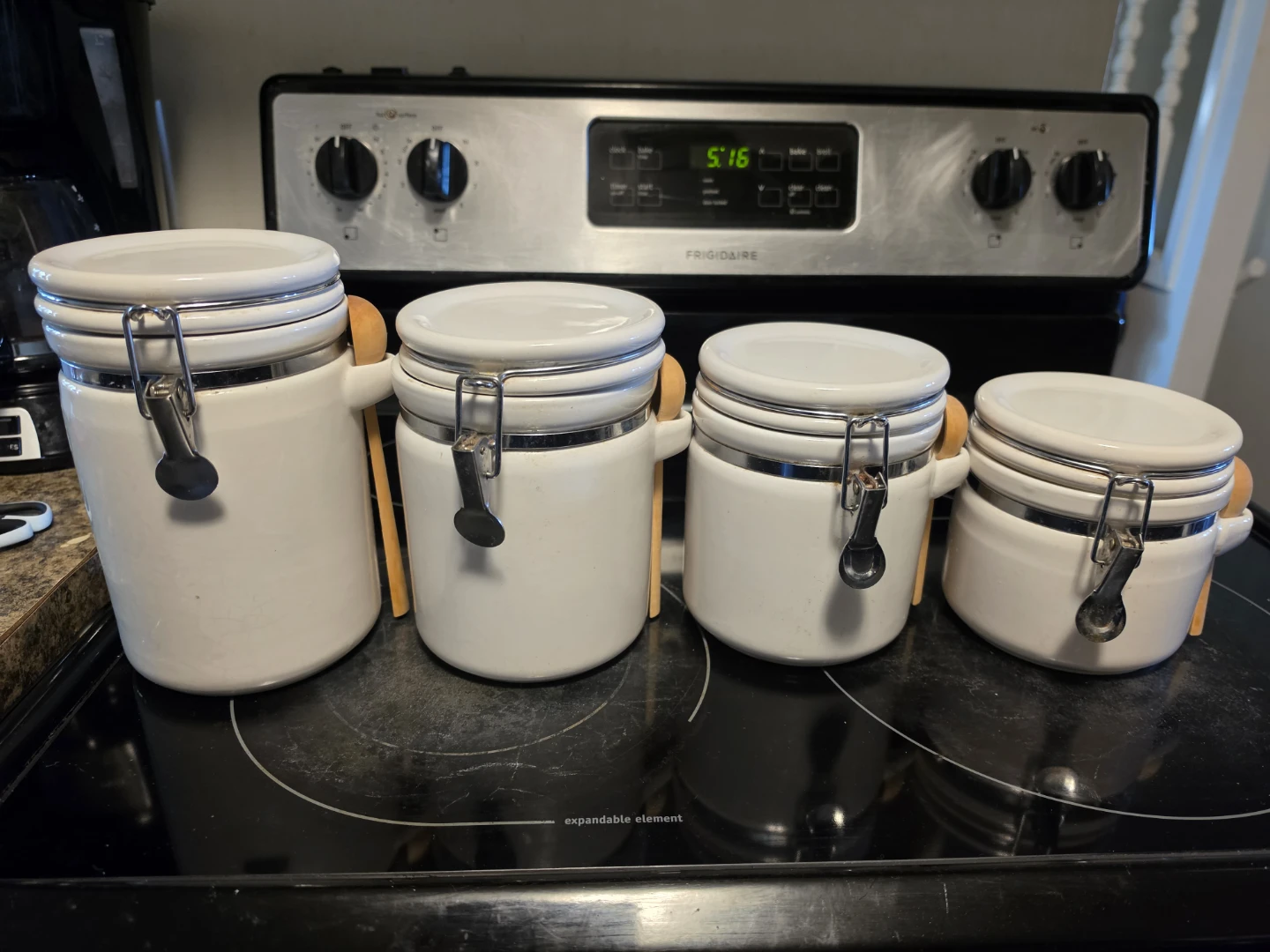 Set of 4 White Ceramic Canisters with Wooden Spoons