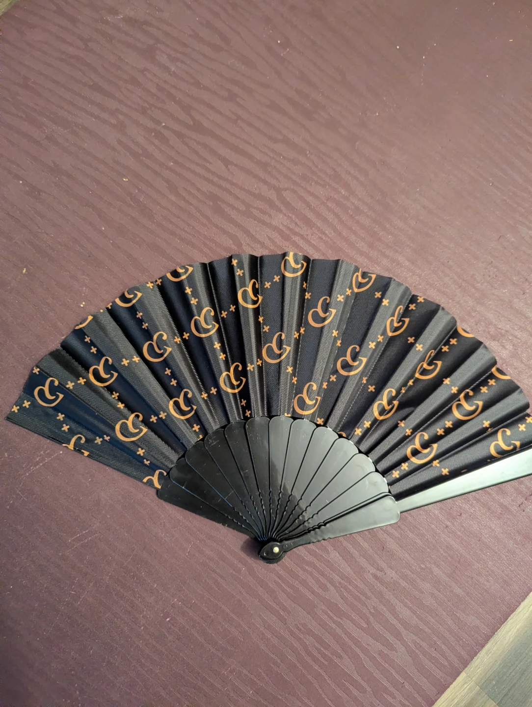Black and gold handheld folding fan