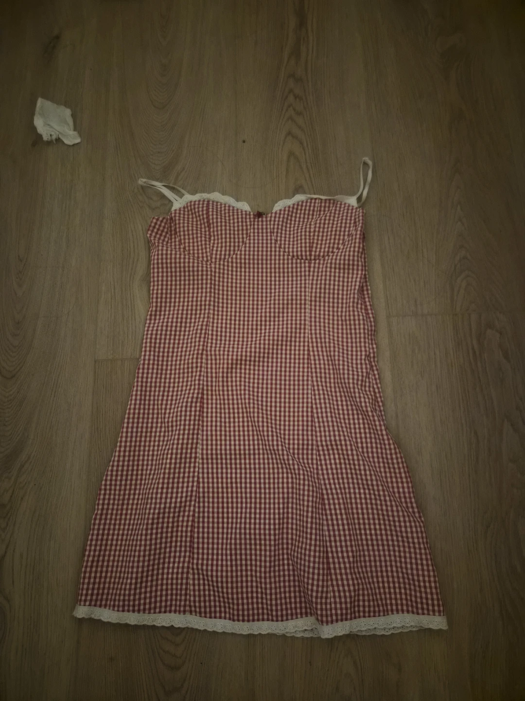 Red gingham mini dress with spaghetti straps and lace trim