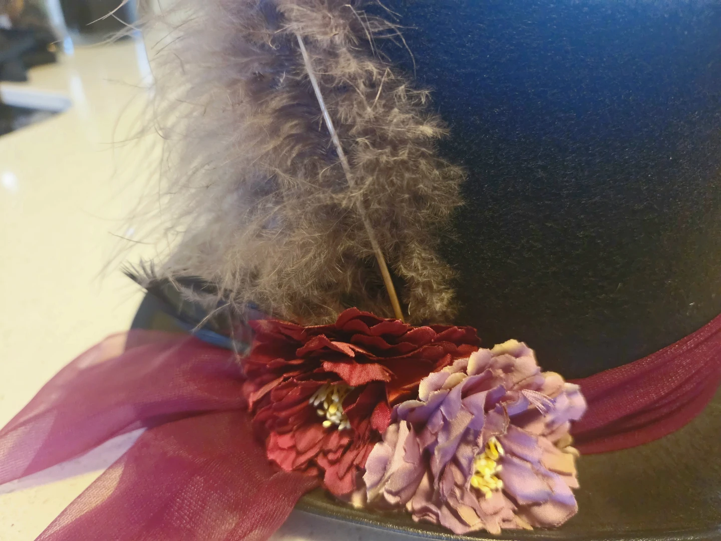 Black top hat with feather and floral trim - photo 2