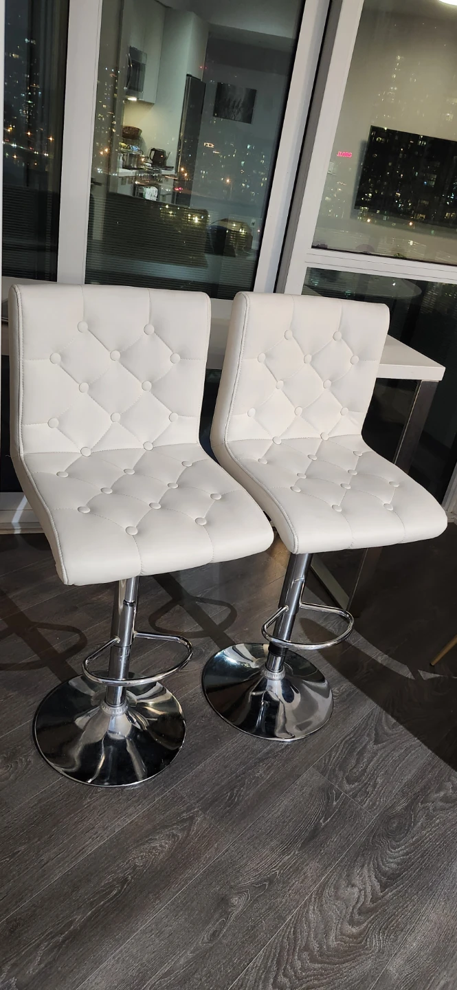 White bar table and two tufted bar stools