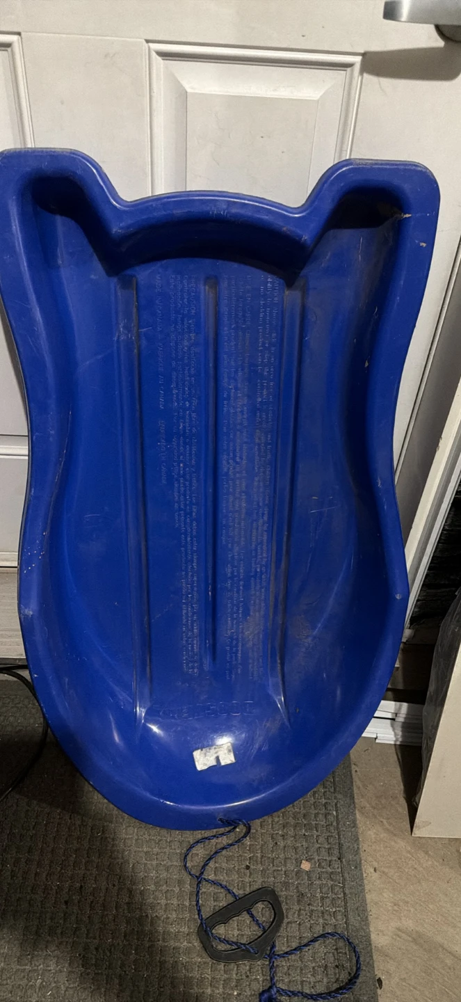 Blue plastic toboggan sled
