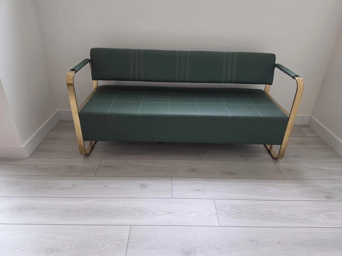 Green faux leather bench with brass-tone frame