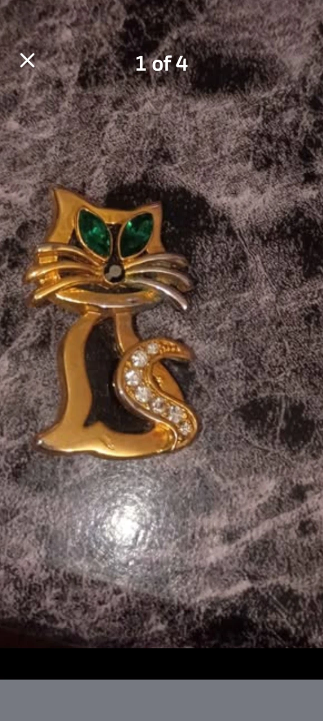 Gold-tone cat brooch with green crystals
