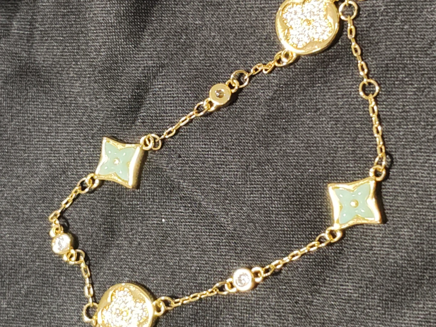 Gold-tone flower and clover charm bracelet
