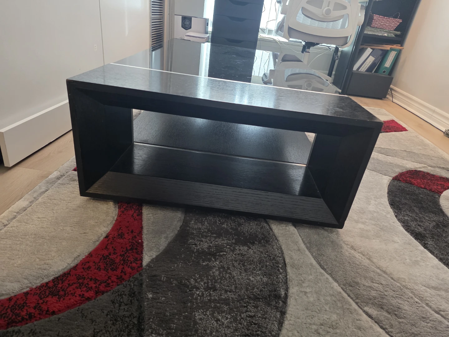 Modern black coffee table with glass top