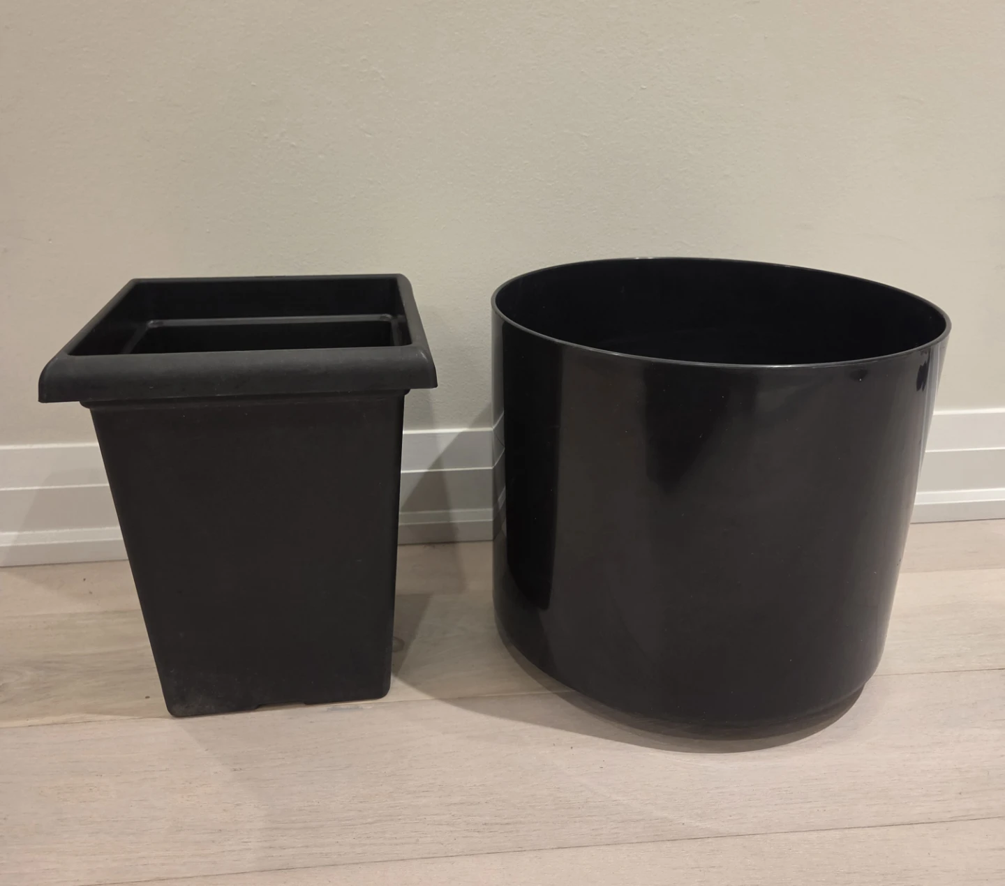 Two large black plastic planters