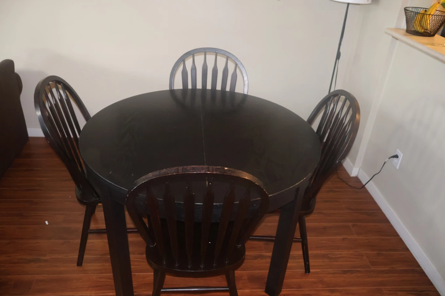Round wooden dining table and four chairs