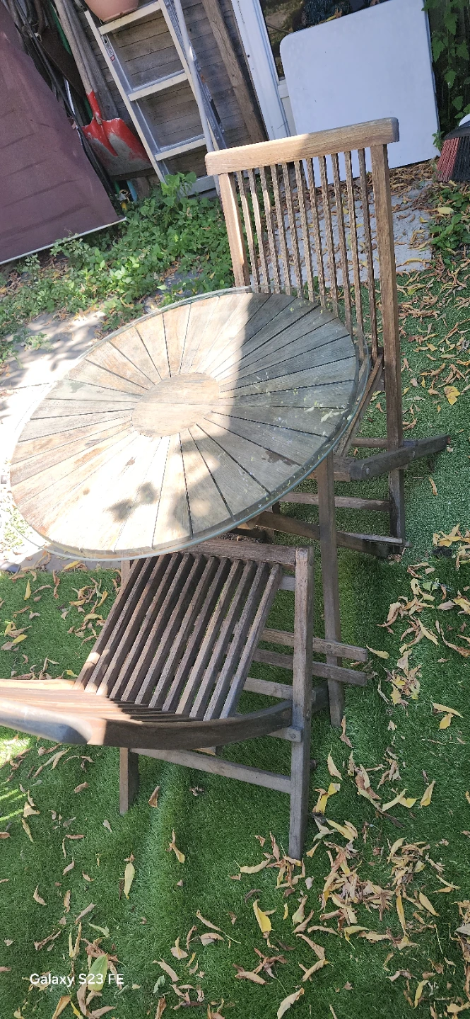 Teak bistro set with folding chairs and glass-top table