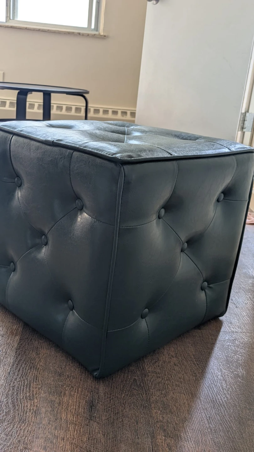 Dark green tufted faux leather ottoman