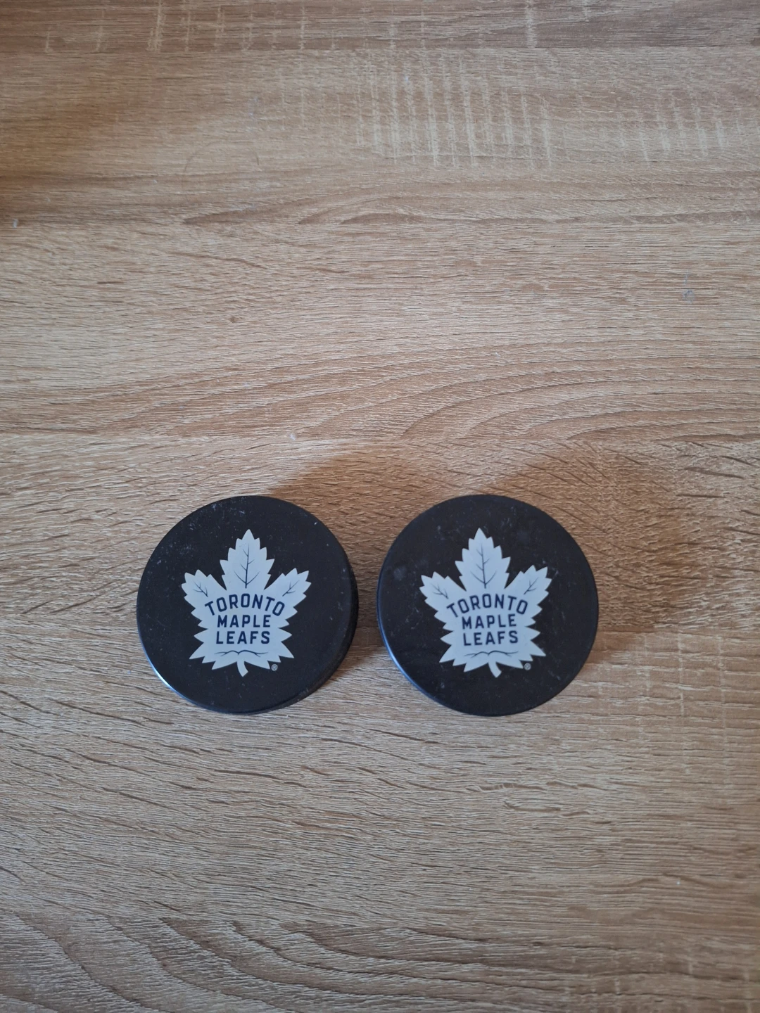 2 Toronto Maple Leafs hockey pucks