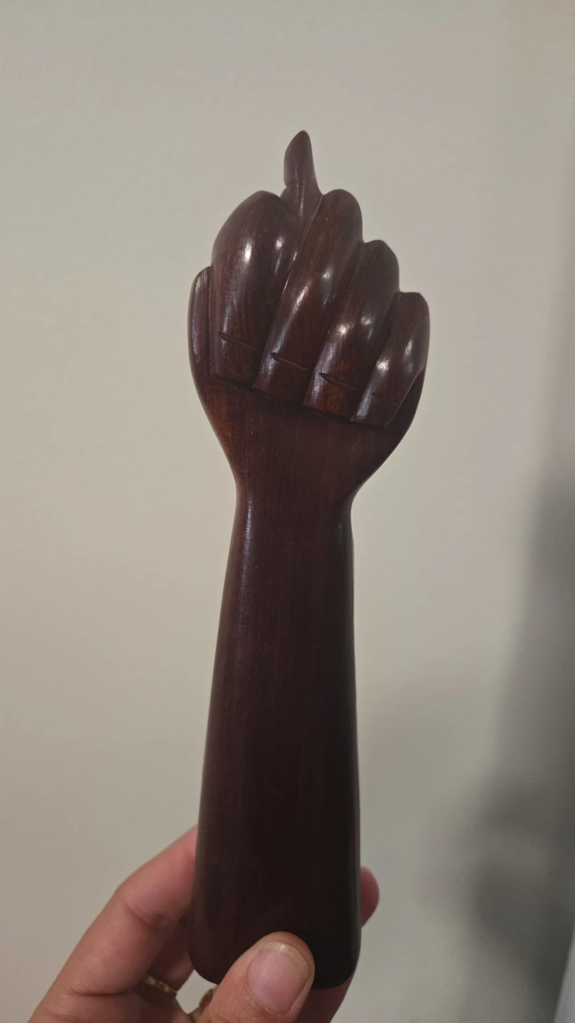 Hand-carved wooden fist sculpture