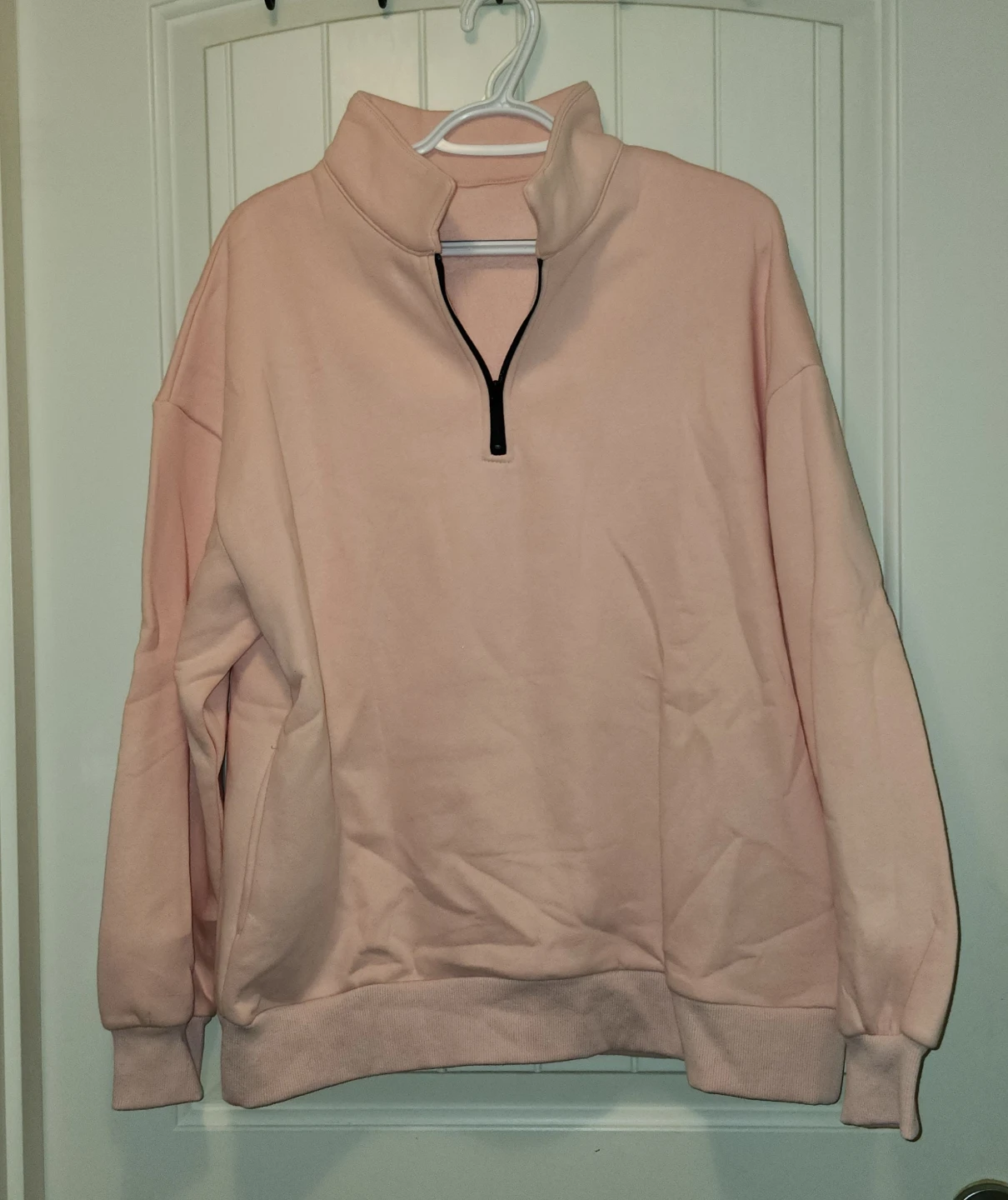 Light pink quarter-zip sweatshirt