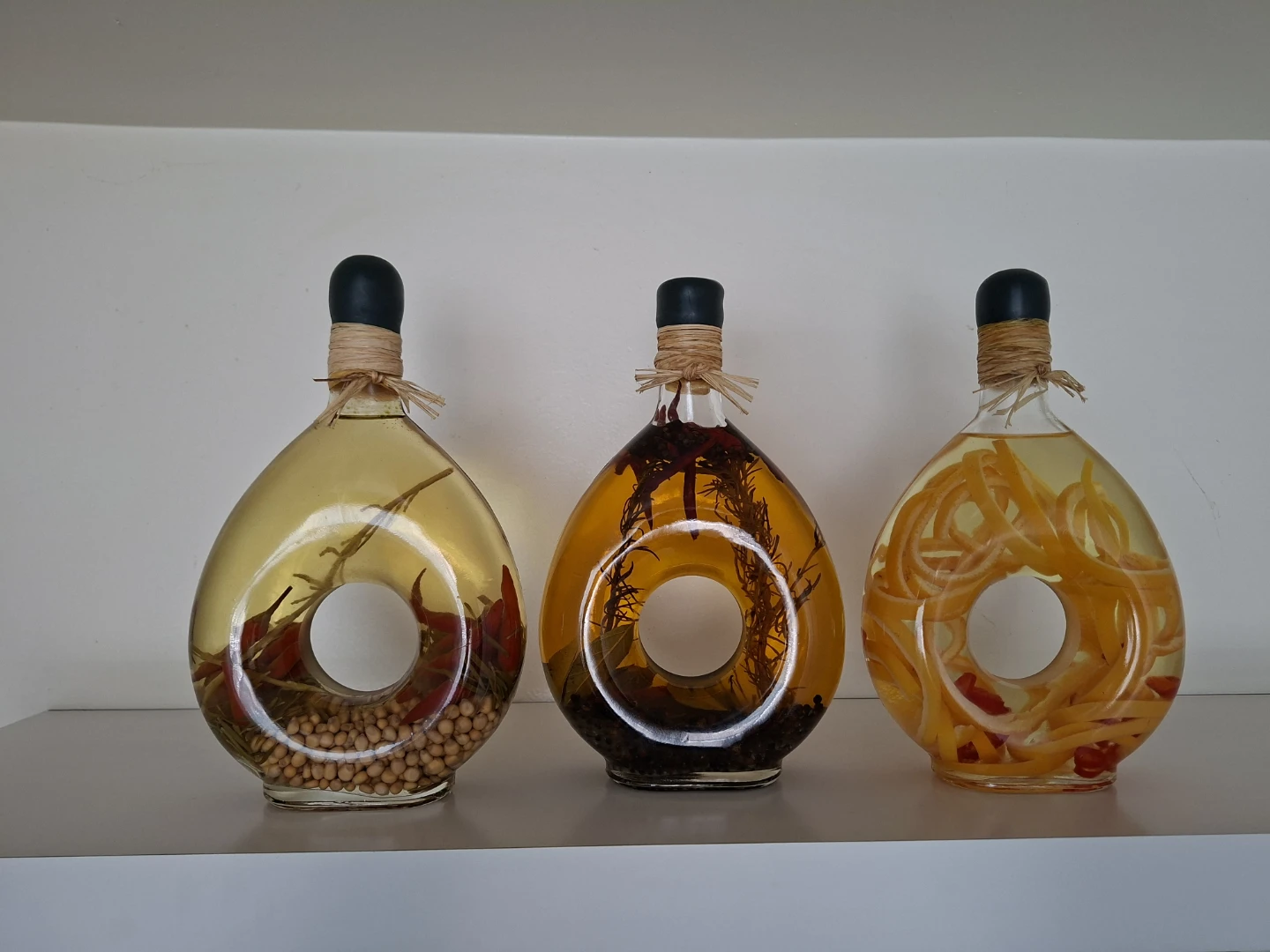 Decorative Infused Oil Bottles & a white shelf - photo 2