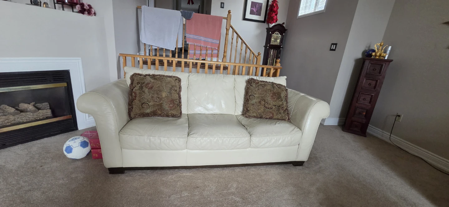 Two Cream Leather Three-Seater Sofa